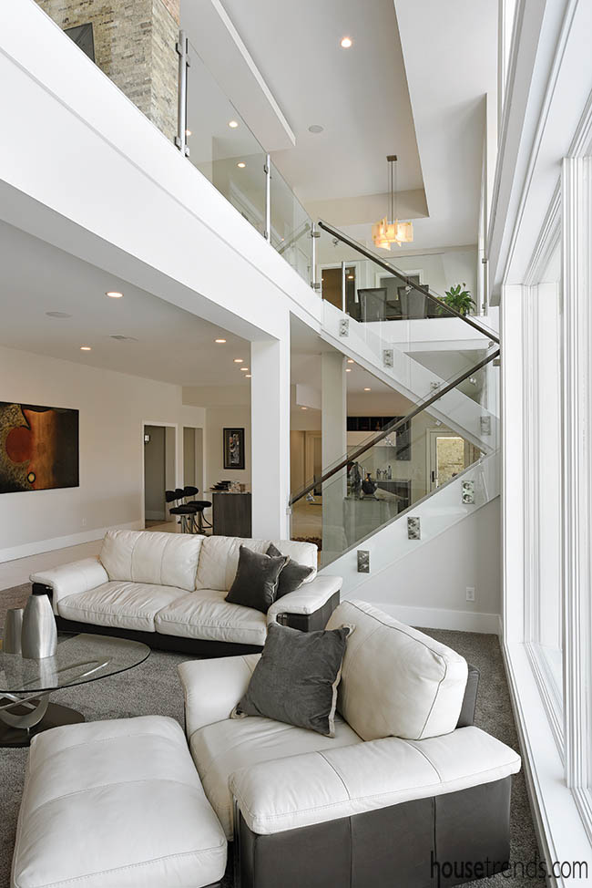 Glass staircase railing blends two levels