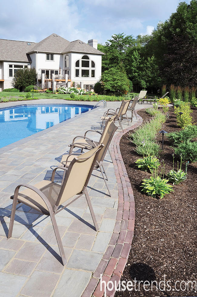 Large paver patio keeps a pool area looking neat