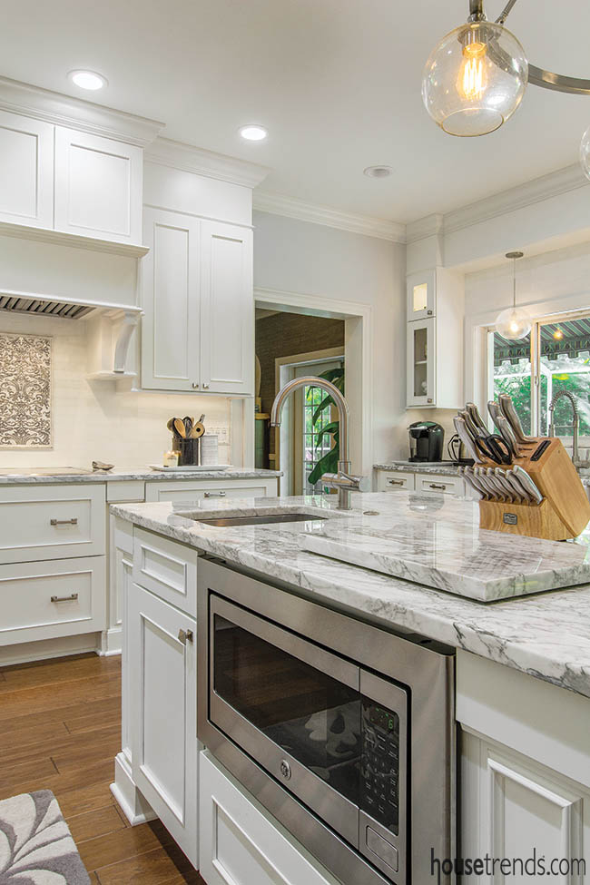 Kitchen island houses convenient appliances