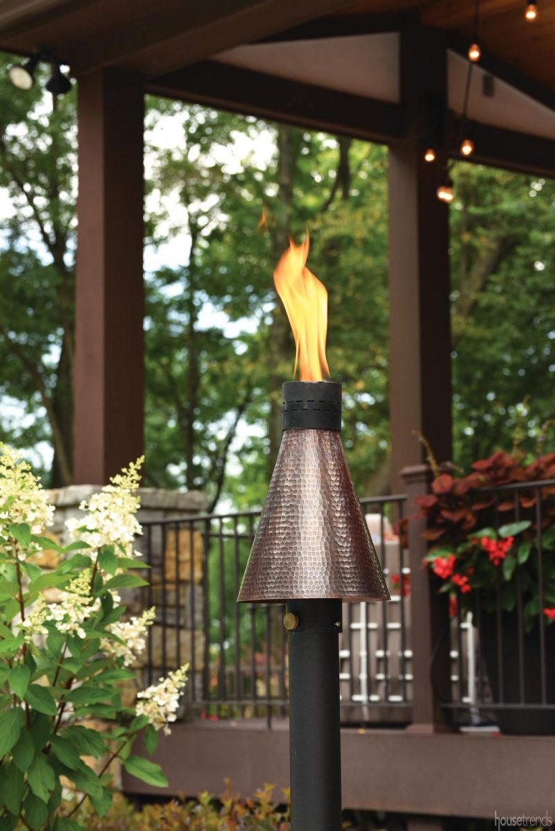 Gas fire torches light up a back yard