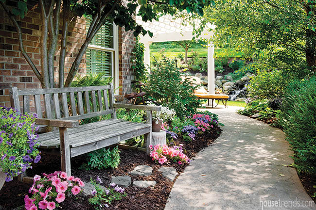 Colorful blooms surround a garden bench