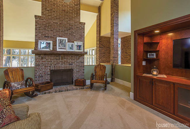 Brick fireplace dominates a sitting area