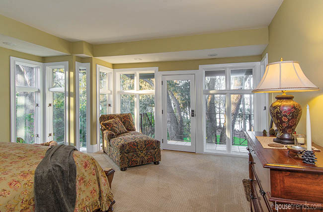 Windows, balcony afford generous view to master bedroom