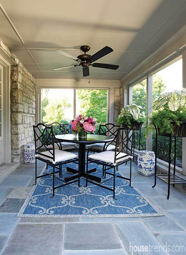 Bluestone pavers run through a screened-in porch