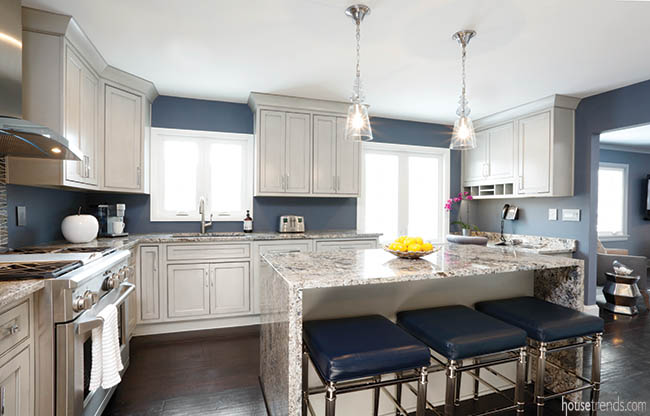 Blue bar stools pop against gray kitchen cabinets