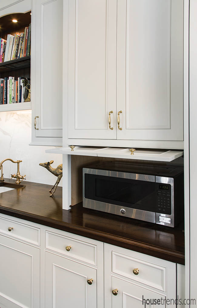Kitchen appliances tucked away behind cabinetry