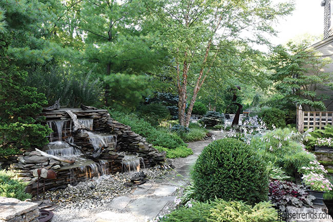 Paver stone walking paths wind through a back yard