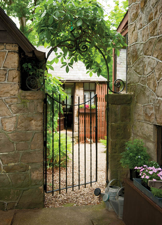 Antique-looking garden fencing helps to set the tone of this home