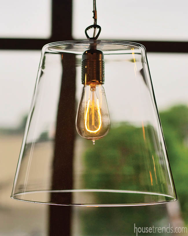 Light fixture dangles over a rustic work space