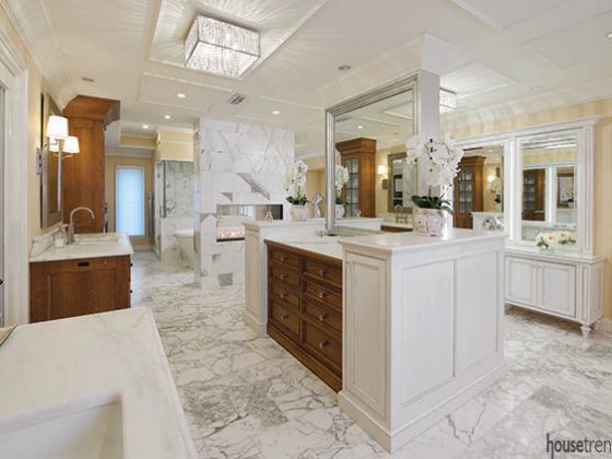 Double-sided fireplace heats up a master bathroom design