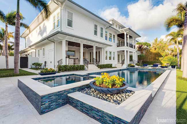 Glass mosaic tile complements a back yard pool