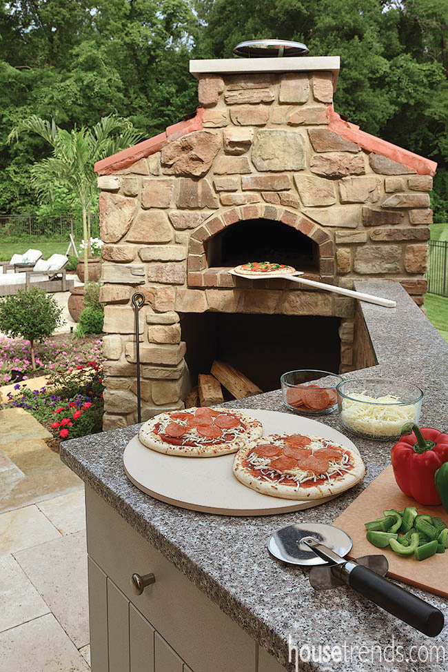 Outdoor pizza oven fits perfectly into a back yard design