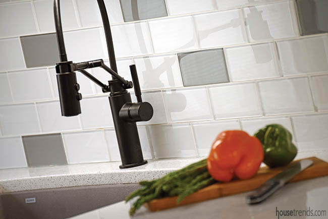 Cool colors make up a glass tile backsplash