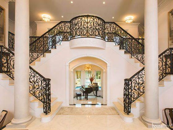 Stair railing dominates the entryway