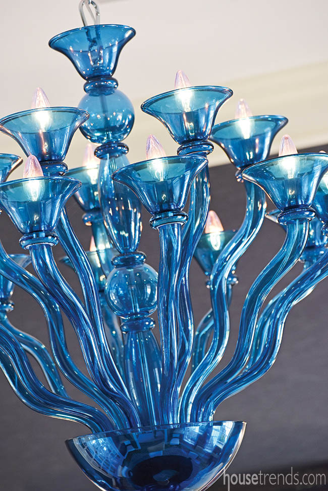 Dining room boasts a blue glass chandelier