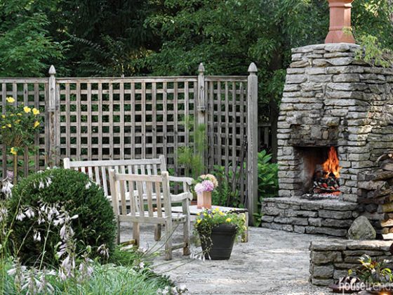 Formal sitting area surrounds an outdoor fireplace