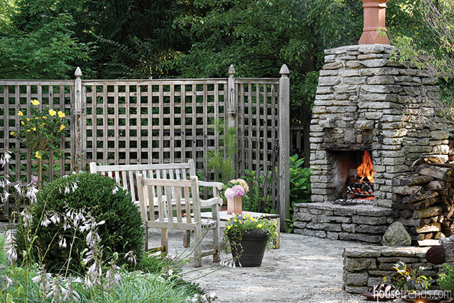 Formal sitting area surrounds an outdoor fireplace