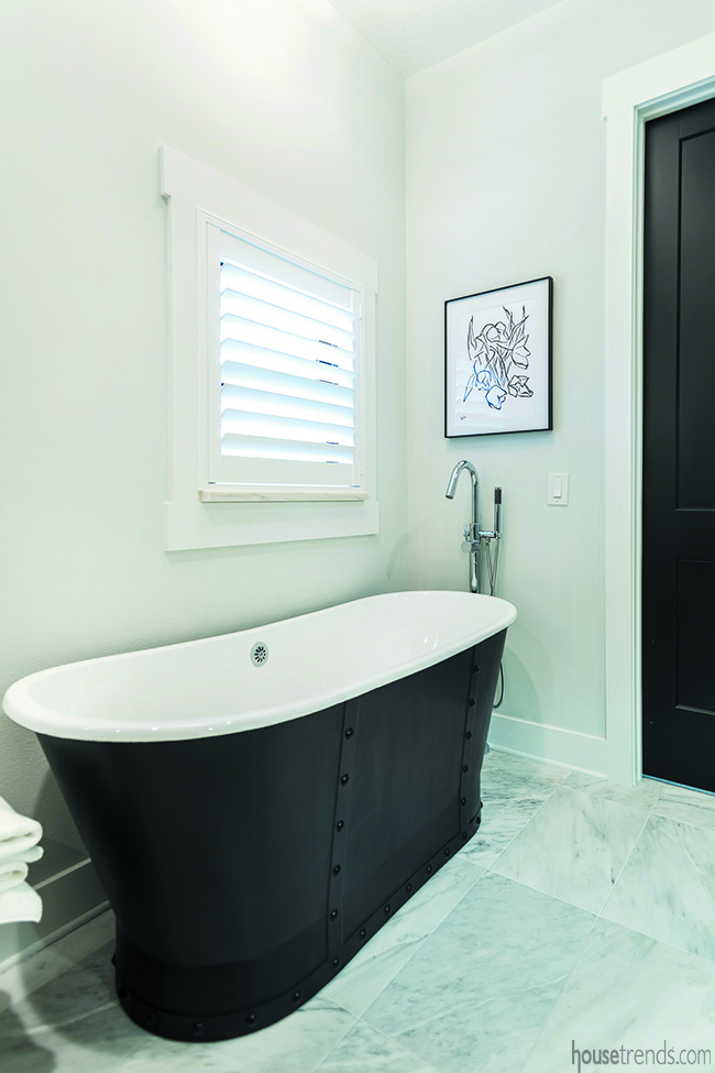 Black bathtub in a master bathroom