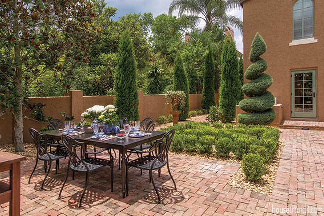 Brick courtyard hosts an outdoor dining area