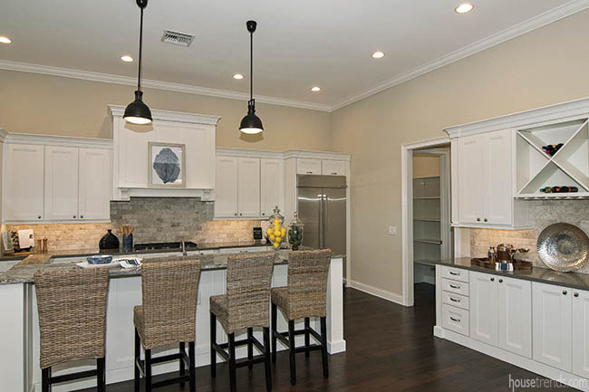 Gray backsplash offsets white kitchen cabinetry