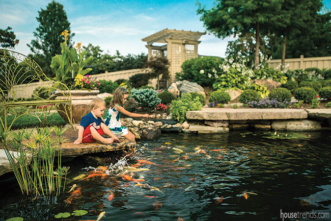 Landscaping rocks add seating options around a pond