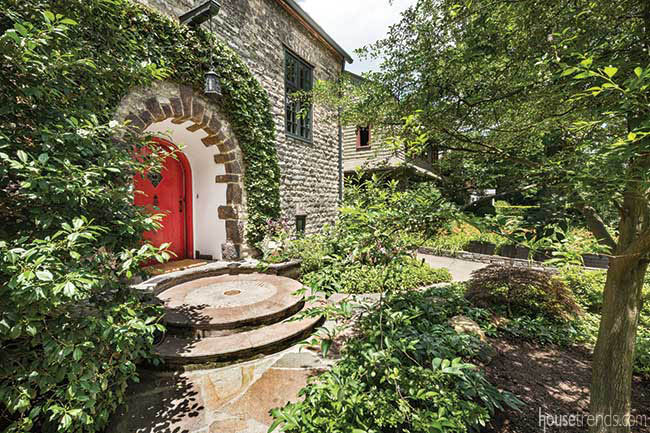 Red door lends a magical feel to a garden