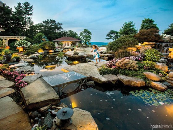 Glass bridge creates a path over a Koi pond