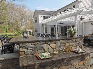 An oversized outdoor bar allows for a private gathering space