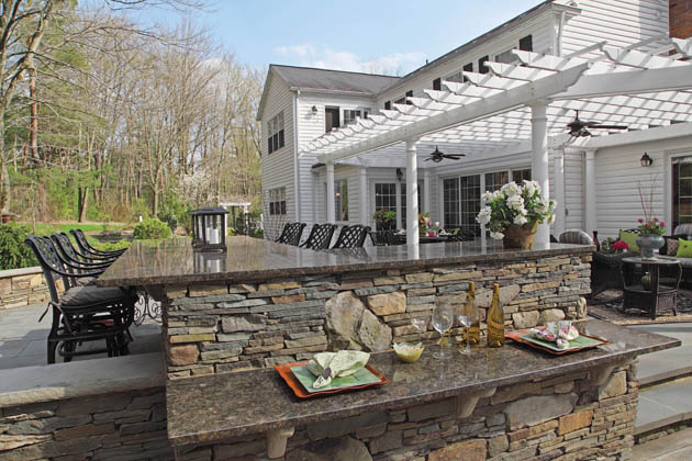 An oversized outdoor bar allows for a private gathering space