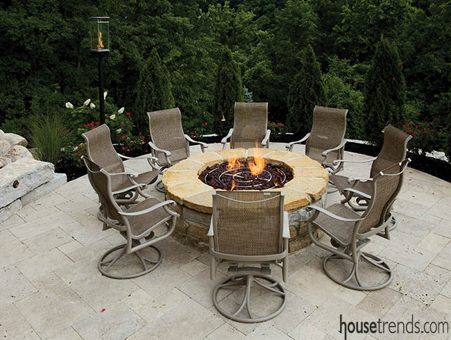 Chairs create a natural gathering space around an outdoor fire pit