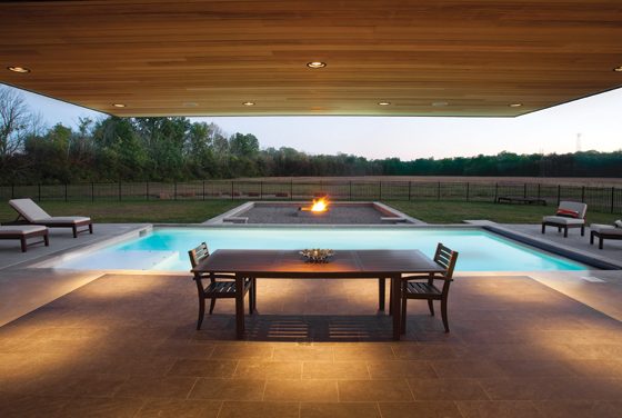 A minimalistic patio is covered by a cantilevered roof