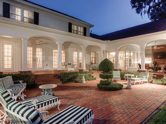 Brick paver patio dominates a back yard