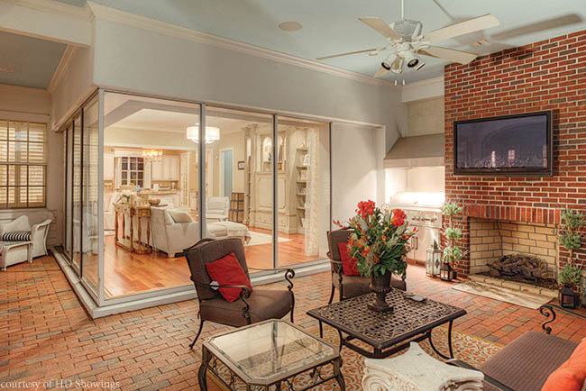 Sliding glass doors connect a family room and outdoor patio