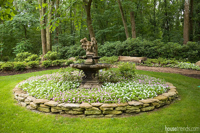 Colorful flowers surround a statue