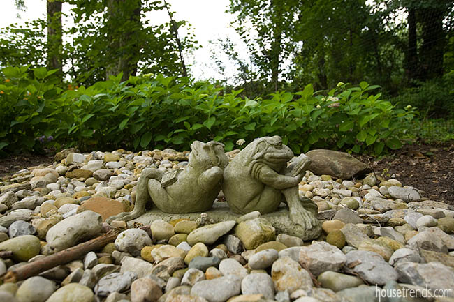 Frog statues add whimsy to a back yard