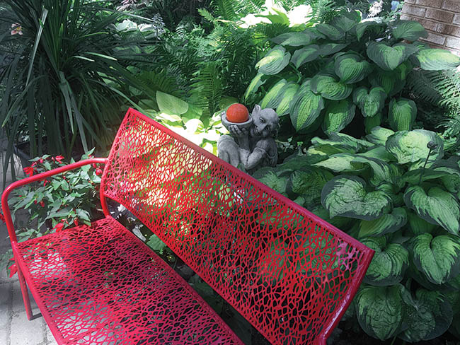 Garden bench introduces color to a back yard