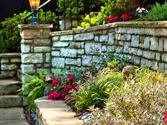 Flowers spill over a garden wall