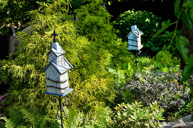 Birdhouses scattered throughout a garden