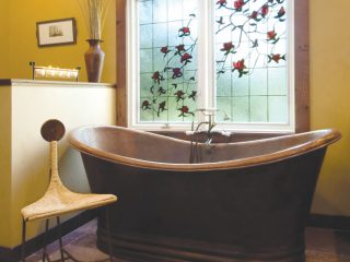 Bath tub and window give off a regal feel