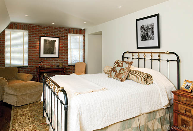 Brick wall adds character to a bedroom design