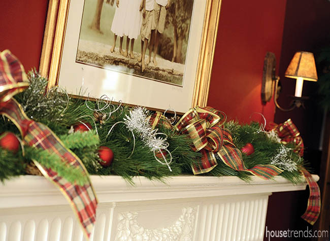 Holiday decorations dress up a dining room fireplace