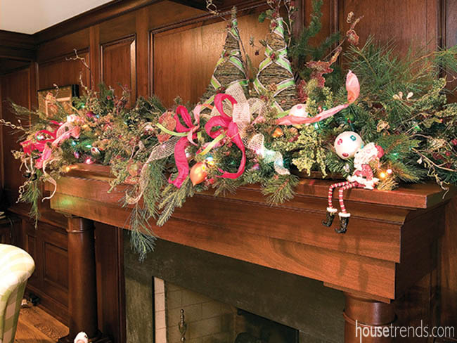 Greenery dresses up a fireplace mantel for the holiday season
