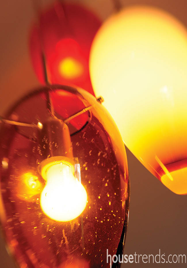 Pendant lights shine on a kitchen peninsula