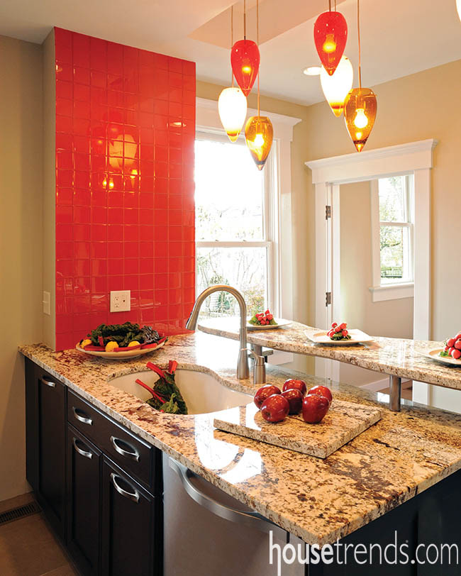 Pendant lights hover over a kitchen peninsula
