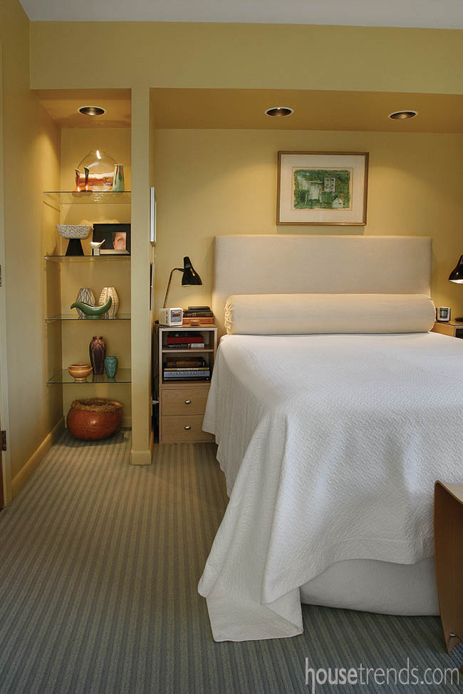 Master bedroom shelving shows off artwork