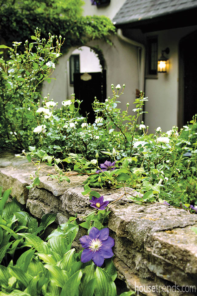 Flowers and plants dress up a stone wall