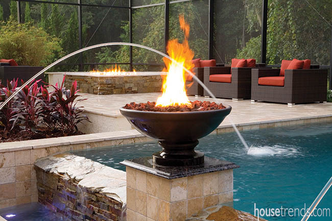 Fire bowls lend dramatic flair to a swimming pool