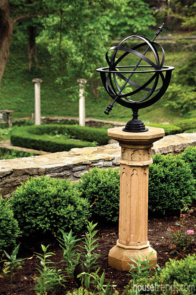 Armillary sphere contrasts with the nearby plants