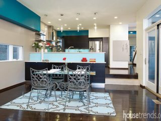 Blue area rug draws eyes and defines a space