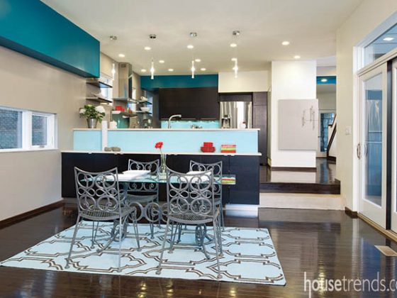 Blue area rug draws eyes and defines a space